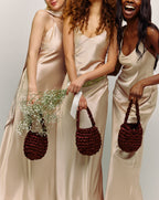 Burgundy bridal bag lifestyle - luxury wedding clutch for modern brides and wedding guests