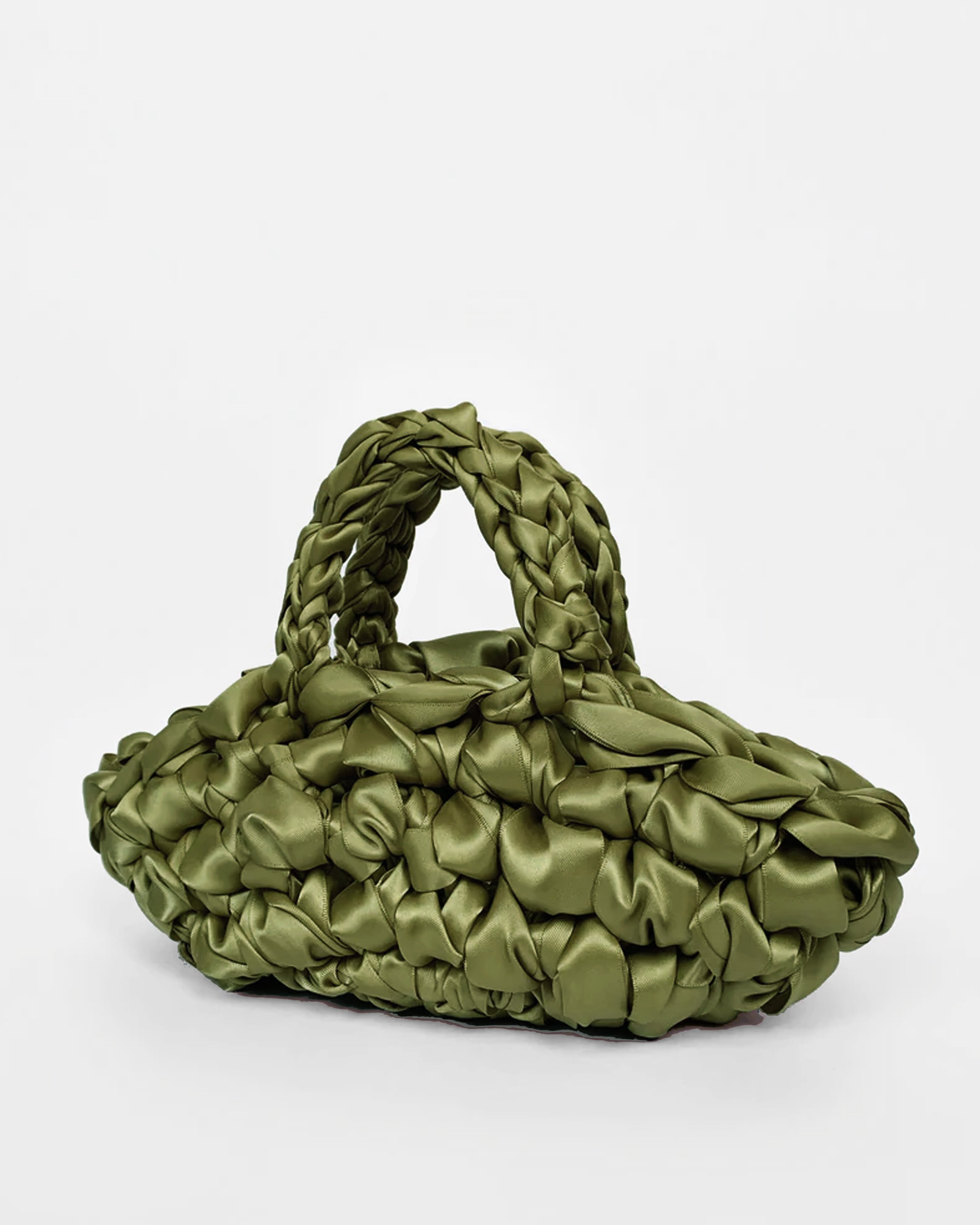 The Quintessential Bridal Bag. Introducing the Nest. Every ISLA DE GAR bag begins with a ribbon, a crochet hook, and a pattern - but that's where the similarities end. This unique design weaves together two lengths of satin, creating a beautifully tactile, sculptural croissant bag that's irresistibly plush and impossible to ignore.