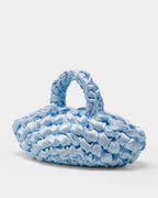 The Quintessential Bridal Bag. Introducing the Nest. Every ISLA DE GAR bag begins with a ribbon, a crochet hook, and a pattern - but that's where the similarities end. This unique design weaves together two lengths of satin, creating a beautifully tactile, sculptural croissant bag that's irresistibly plush and impossible to ignore.