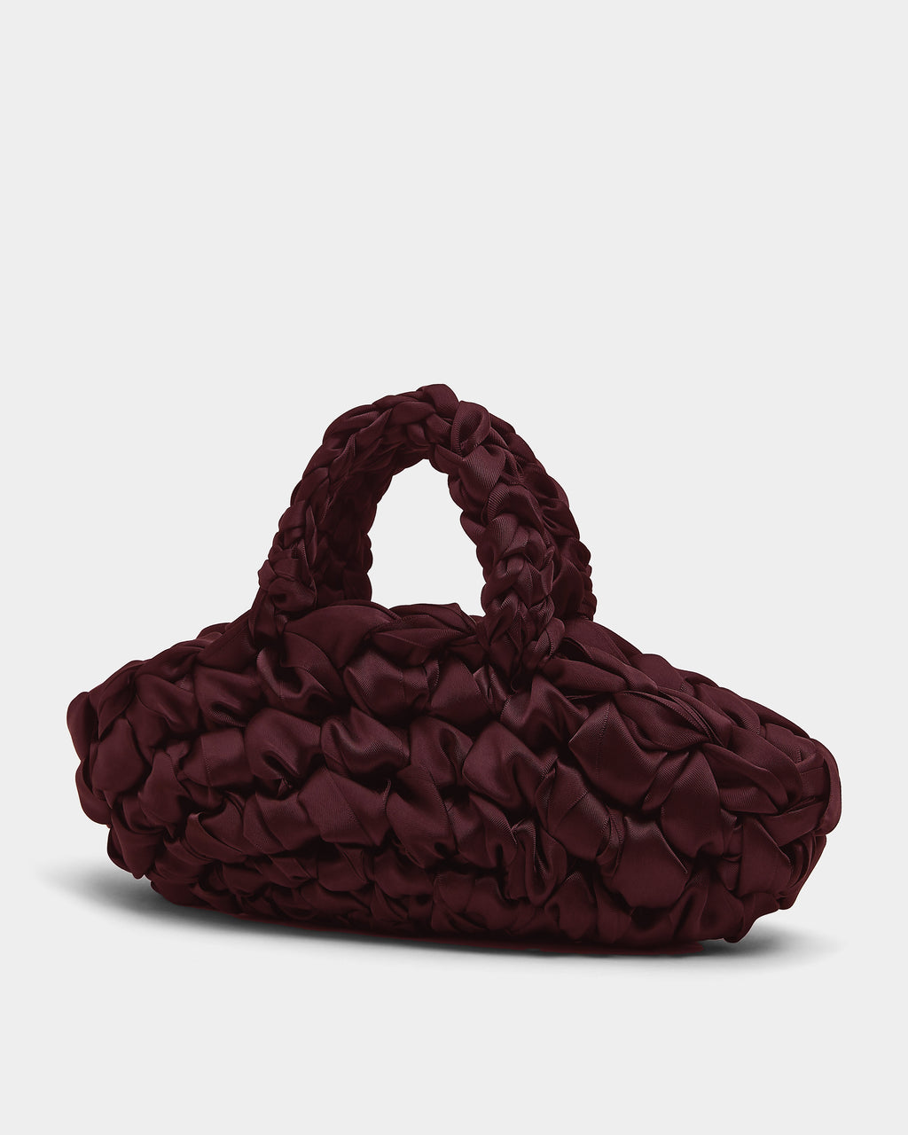 The Quintessential Bridal Bag. Introducing the Nest. Every ISLA DE GAR bag begins with a ribbon, a crochet hook, and a pattern - but that's where the similarities end. This unique design weaves together two lengths of satin, creating a beautifully tactile, sculptural croissant bag that's irresistibly plush and impossible to ignore.