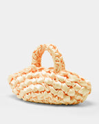 The Quintessential Bridal Bag. Introducing the Nest. Every ISLA DE GAR bag begins with a ribbon, a crochet hook, and a pattern - but that's where the similarities end. This unique design weaves together two lengths of satin, creating a beautifully tactile, sculptural croissant bag that's irresistibly plush and impossible to ignore.